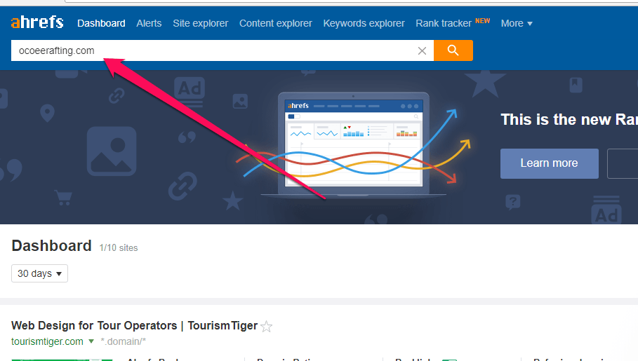 Screenshot of Ahrefs homepage with an arrow pointing to the search bar