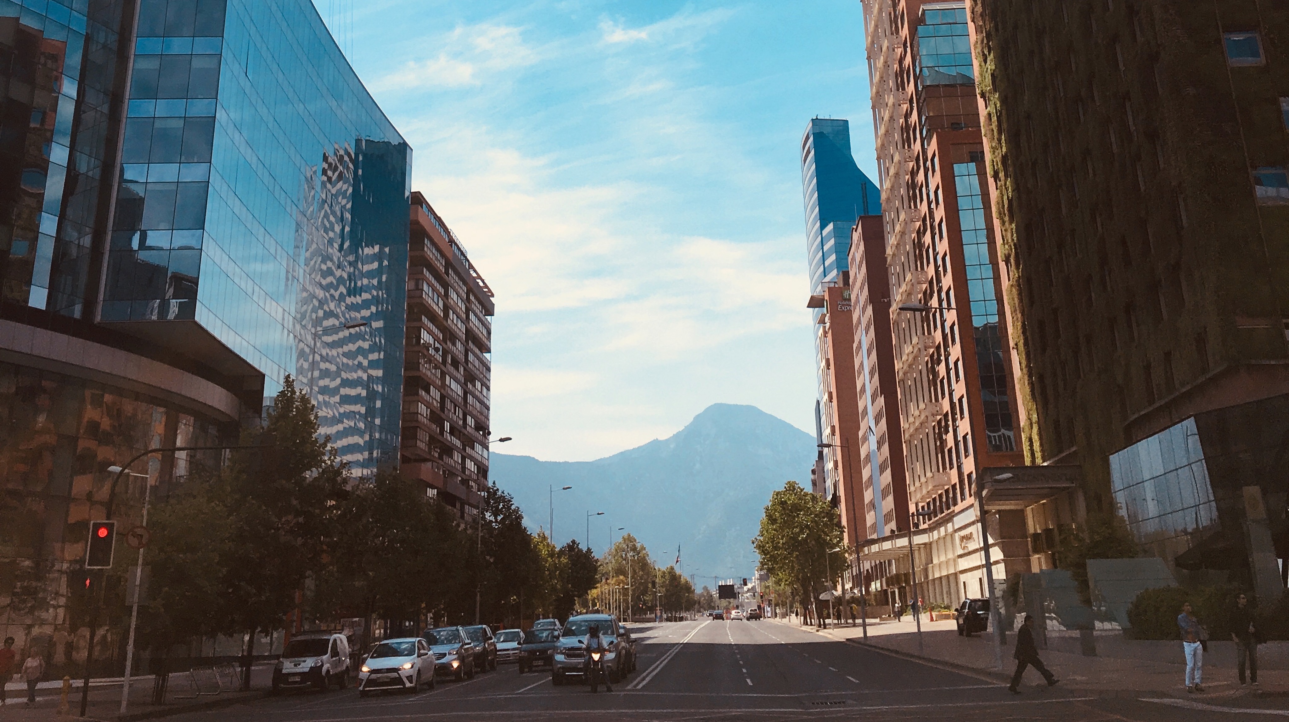 Mountains in the background with buildings lining the street