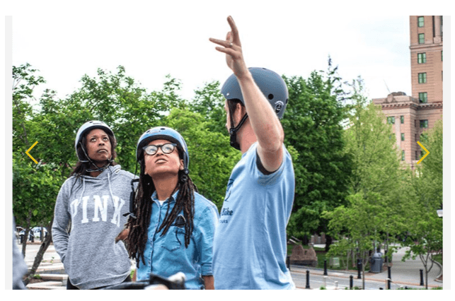 Tour guide demonstrating something to guests on part of The Flying Bike tours