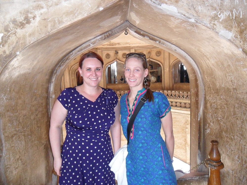 Two women standing in an old doorway