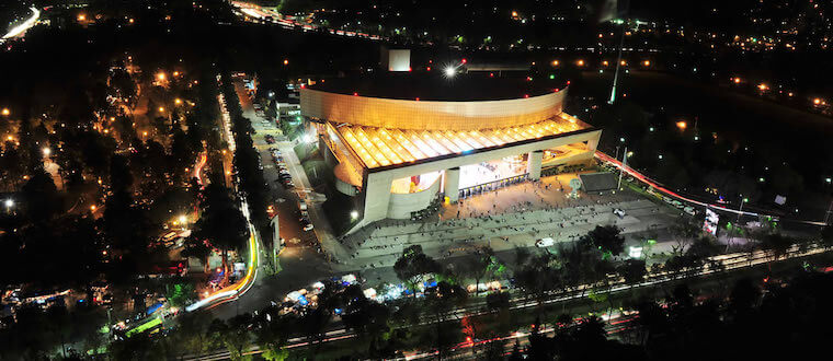 A nightime view of a conference building