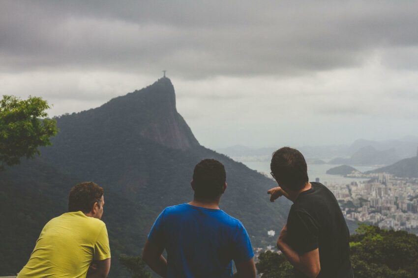 A guide pointing off into the distance towards a mountain