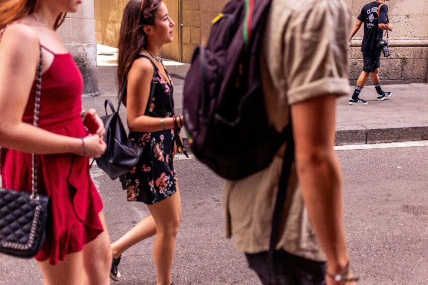 A group of people walking through a city